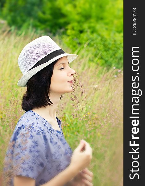 Girl smelling grass on the meadow. Girl smelling grass on the meadow