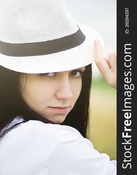 young woman wearing summer straw hat