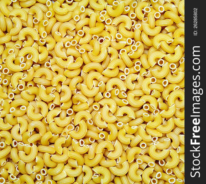Raw yellow pasta background closeup