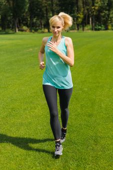 Portrait Of A Young Woman Jogging Stock Images