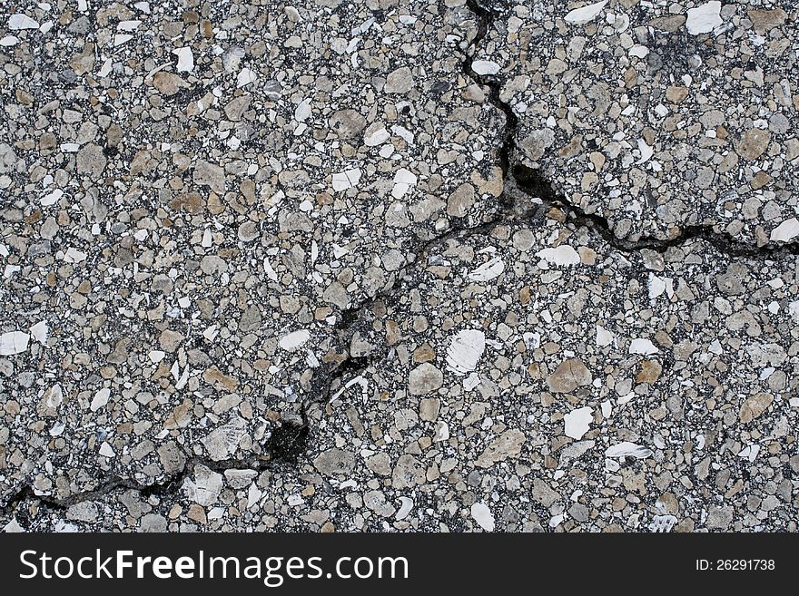 Crack in asphalt road that divides into three different directions. Crack in asphalt road that divides into three different directions