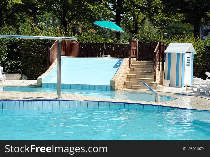 Limpid Swimming Pool And A Waterslide