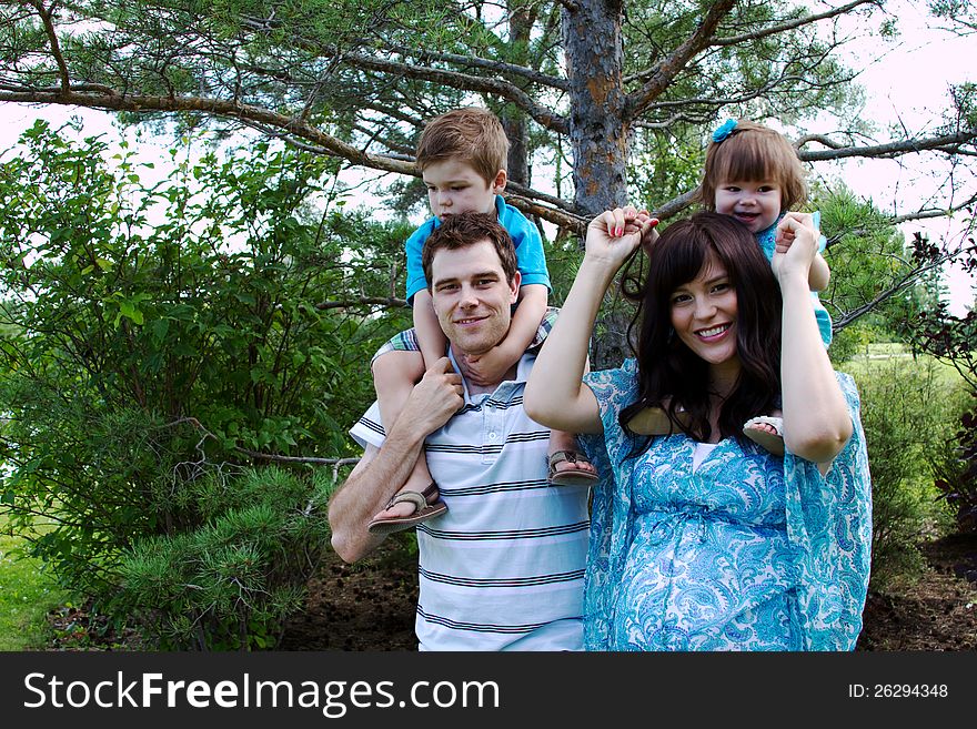 Family of four together in park. Family of four together in park