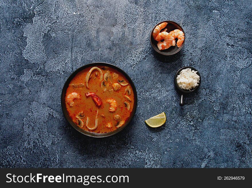 Traditional Asian soup Tom Yam based on coconut milk with seafood. Traditional Asian soup Tom Yam based on coconut milk with seafood