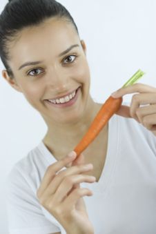 Girl With Carrot Royalty Free Stock Images