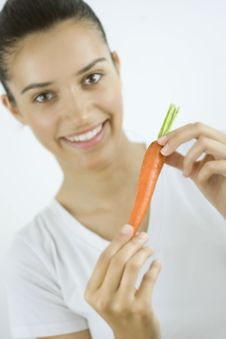 Girl With Carrot Royalty Free Stock Photography