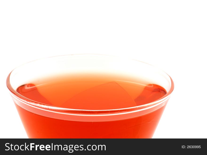 Close up at vivid red drink on a white background. Close up at vivid red drink on a white background