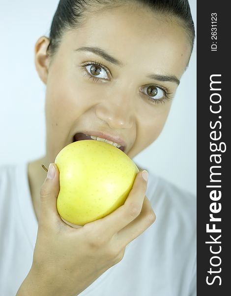 Girl in white eating apple. Girl in white eating apple