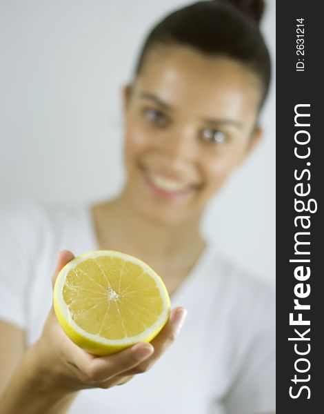 Smiling girl holding piece of citrus. Smiling girl holding piece of citrus