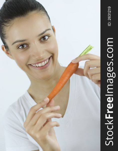 Girl holding carrot with her hands. Girl holding carrot with her hands
