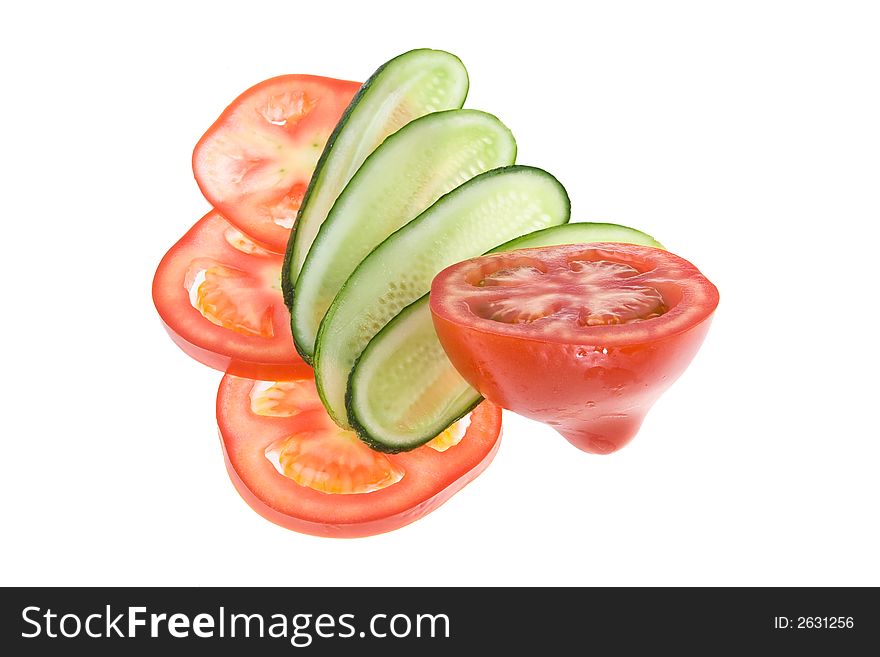 Slices of a cucumber and tomato shined from below. Slices of a cucumber and tomato shined from below