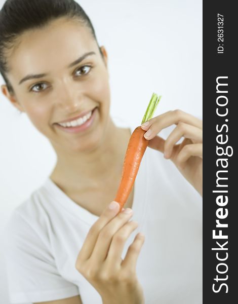 Girl holding carrot with her hands. Girl holding carrot with her hands