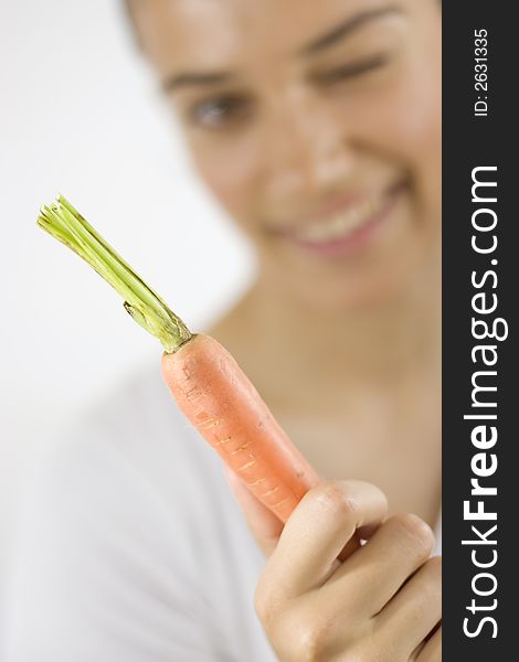 Girl holding carrot with her hand. Girl holding carrot with her hand