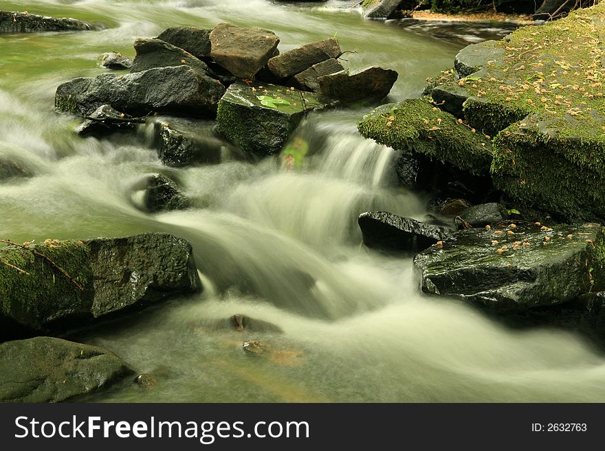 Fast flowing water down a  stream