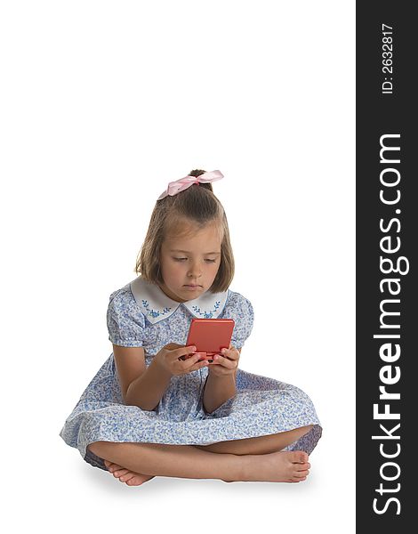 A young, Caucasian girl playing an electronic game. Isolated on white. A young, Caucasian girl playing an electronic game. Isolated on white.