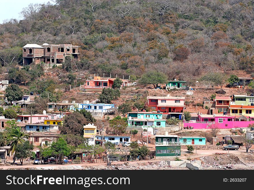 A colorful hillside fishing village on the coast. A colorful hillside fishing village on the coast