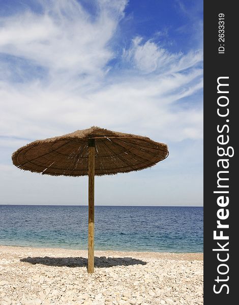 A little sunshade on empty beach in spain