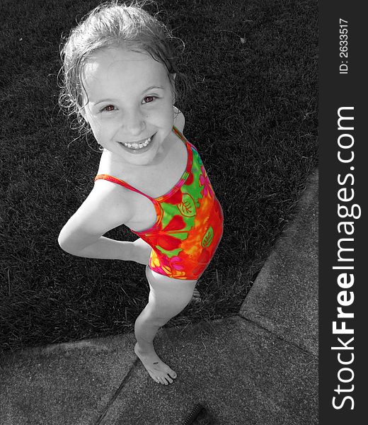 Colorized image of a cute little blonde girl in a bathing suit smiling. Colorized image of a cute little blonde girl in a bathing suit smiling.