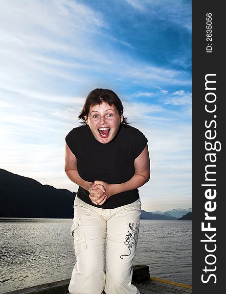 Woman with a smile over blue sky. Woman with a smile over blue sky