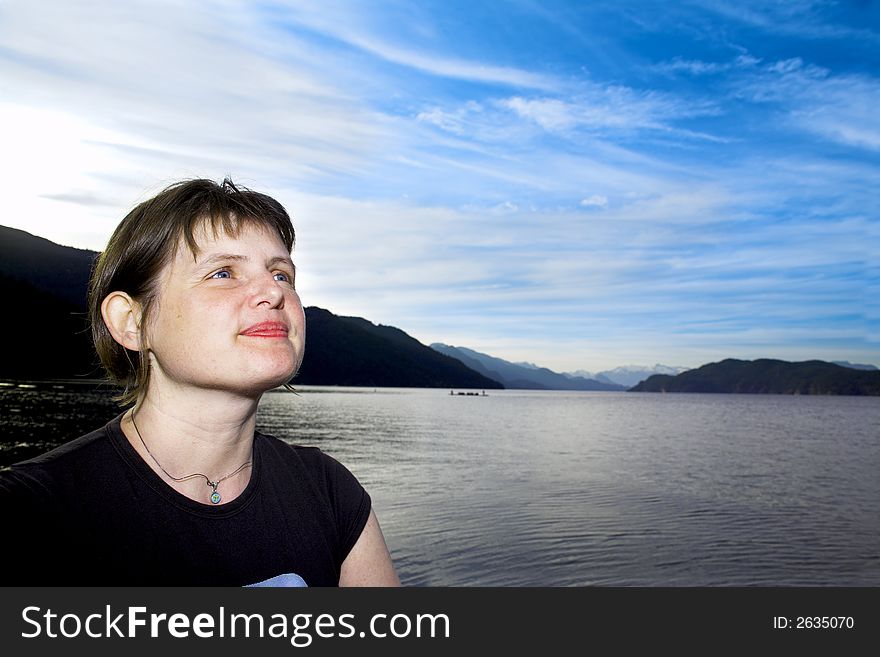 Woman enjoying a scenery over blue sky. Woman enjoying a scenery over blue sky