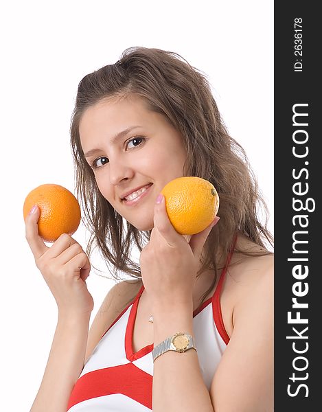 The brown-eyed girl on a white background holds oranges. The brown-eyed girl on a white background holds oranges