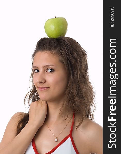 The brown-eyed girl holds a green apple. The brown-eyed girl holds a green apple.