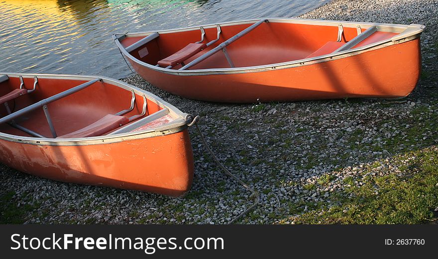 Canoes on the river bank lit with the morning light. Canoes on the river bank lit with the morning light