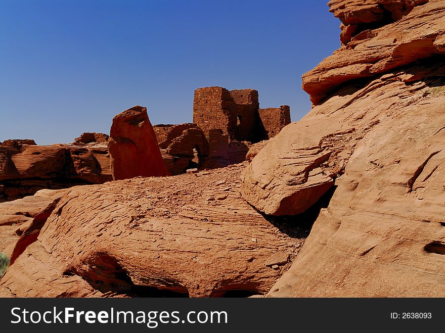 The red rocks on the Wukoki indian pueblo ruins against a blue Arizona sky in Wupatki National Monument