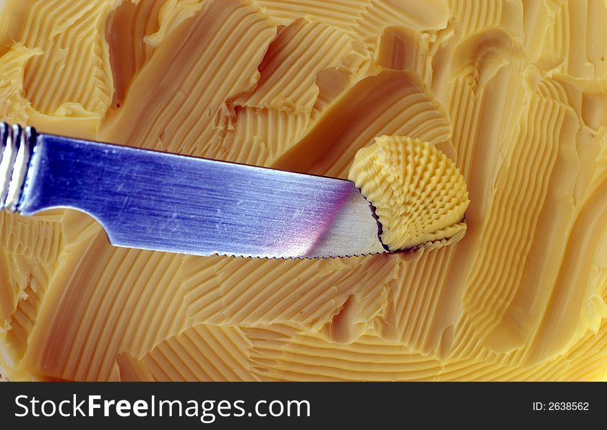 Fresh farm butter, being spread with a knife. Fresh farm butter, being spread with a knife.