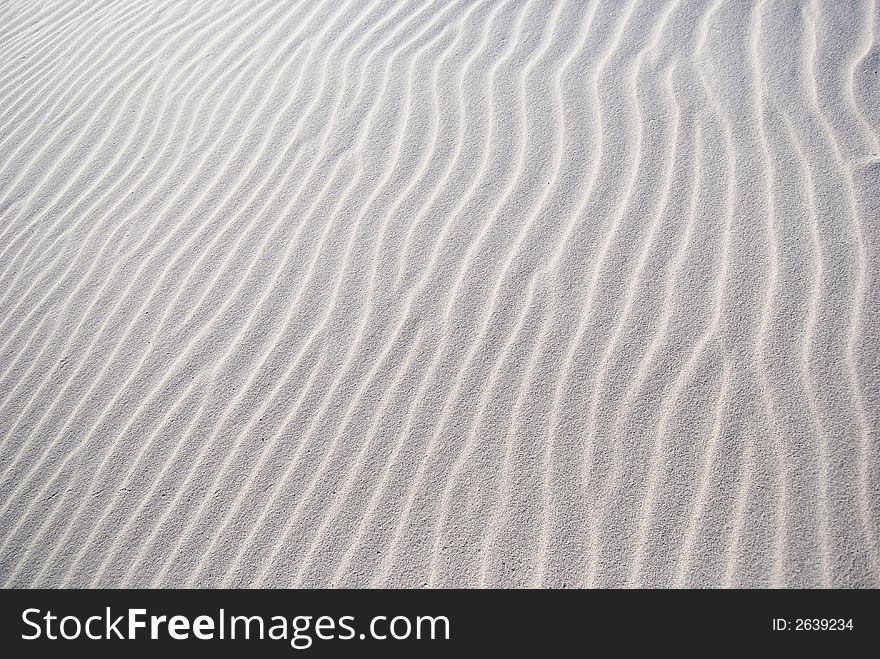 windy pattern on the white sand on the desert. windy pattern on the white sand on the desert