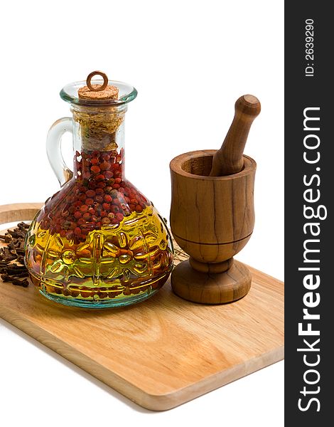 Bottle of olive oil  and vessel on cutting board. Bottle of olive oil  and vessel on cutting board.