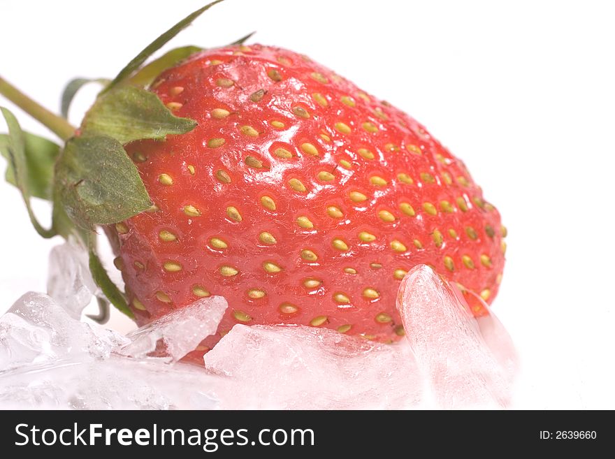 Fresh strawberry on ice chips against a white background
