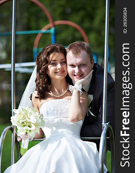 Happy bride and groom on swing at wedding day. Happy bride and groom on swing at wedding day