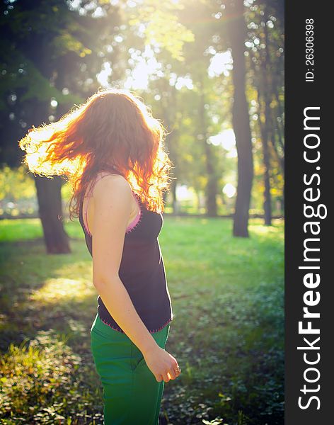 Redhead girl is jumping at the sunset