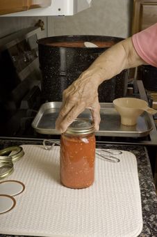 Placing Lid On Can Of Tomatoes. Royalty Free Stock Photos Placing Lid On Can Of Tomatoes. Royalty Free Stock Photos