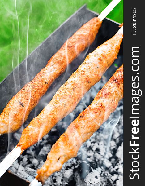 Delicious juicy meat kebab on outdoors grill. Delicious juicy meat kebab on outdoors grill