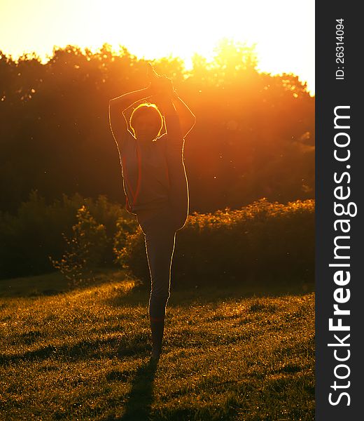 The young girl to do exercises on nature in the morning. The young girl to do exercises on nature in the morning