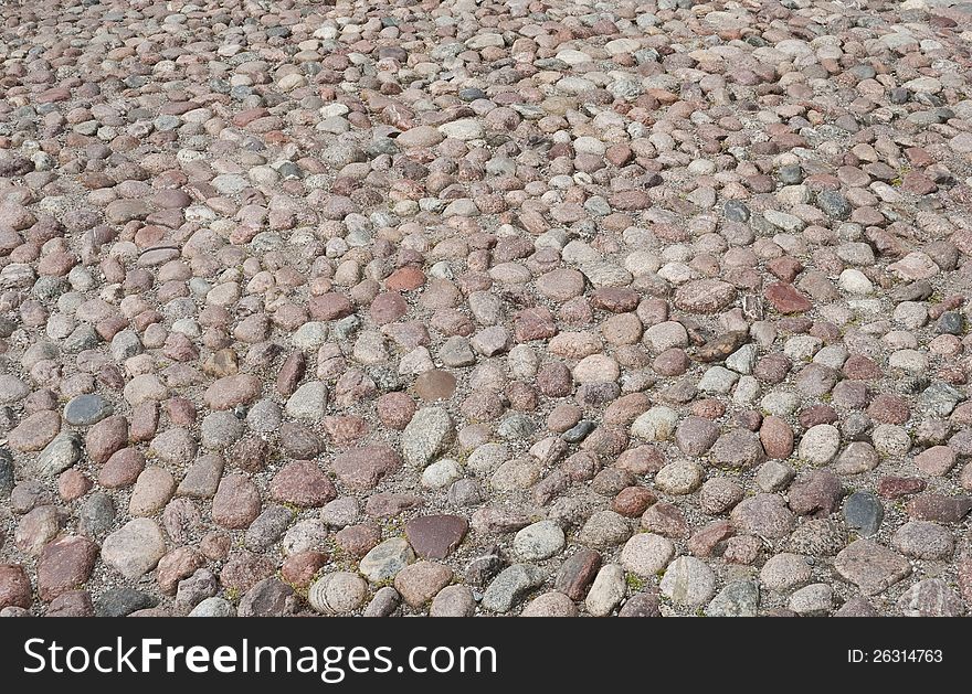 Old road paved with the cobble stones, background