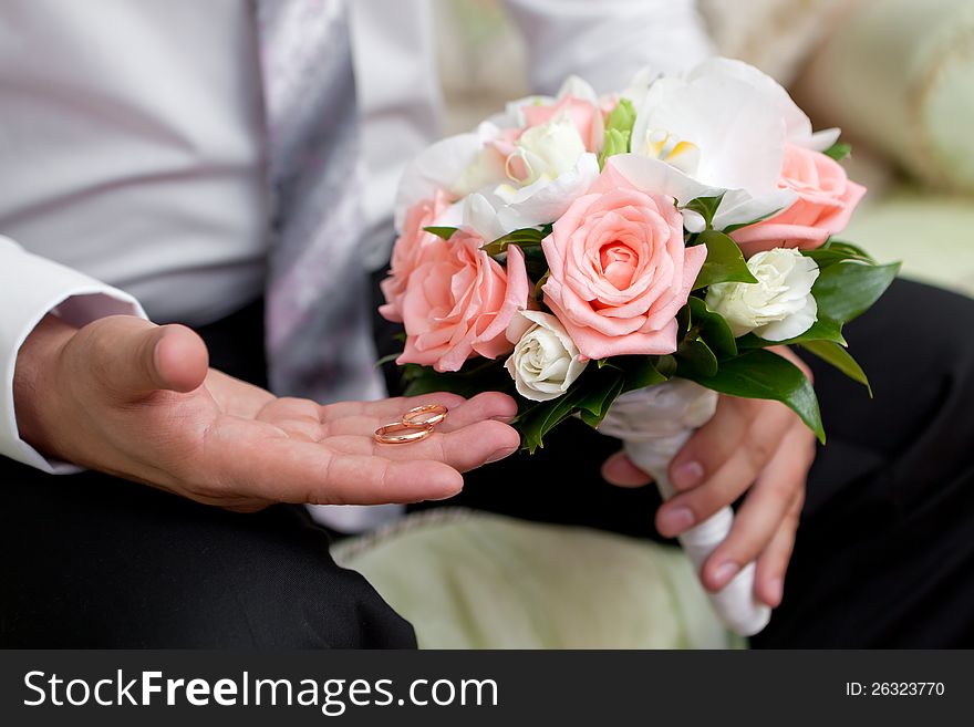 Gold wedding rings on a hand of the groom