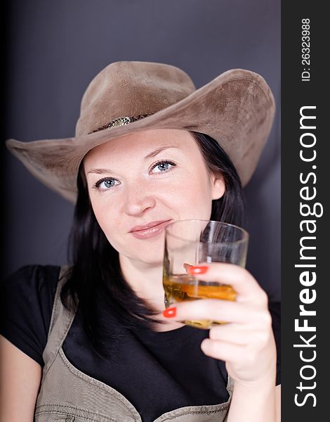 Girl drinking whiskey on dark background