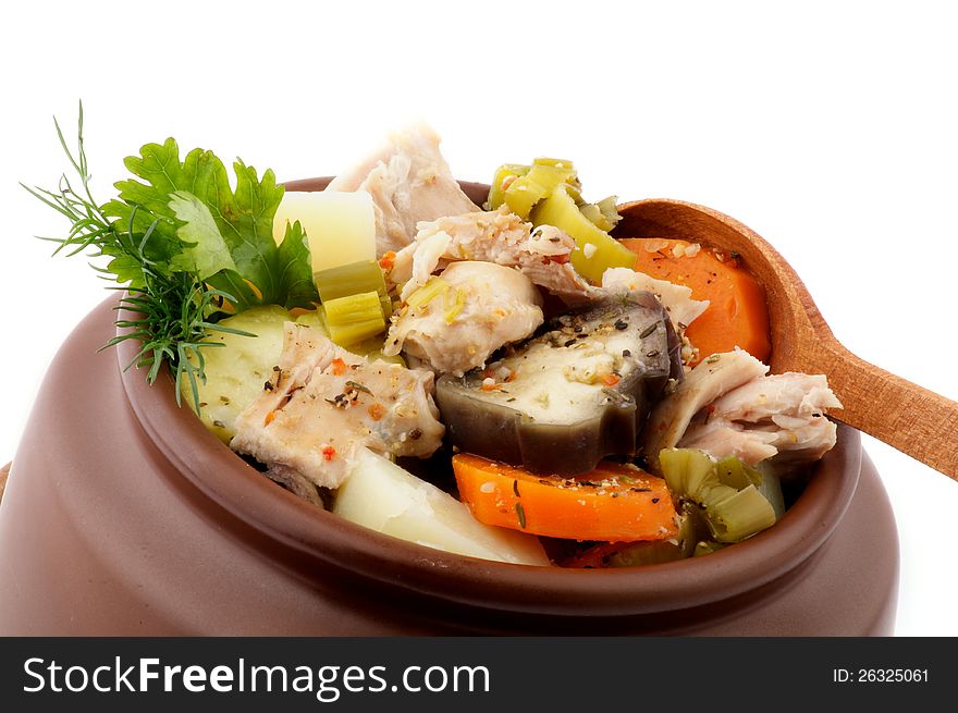 Hearty Vegetable and Chicken Stew in Brown Pot with Wooden Spoon isolated on white background