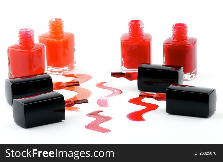 Four Bright Nail Varnishs and Spilled with Brushes isolated on white background