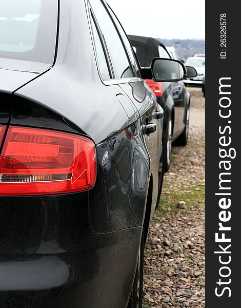 A rear view of a brand new car in a car-park