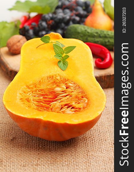 Slice of pumpkin with fresh fruits and vegetables