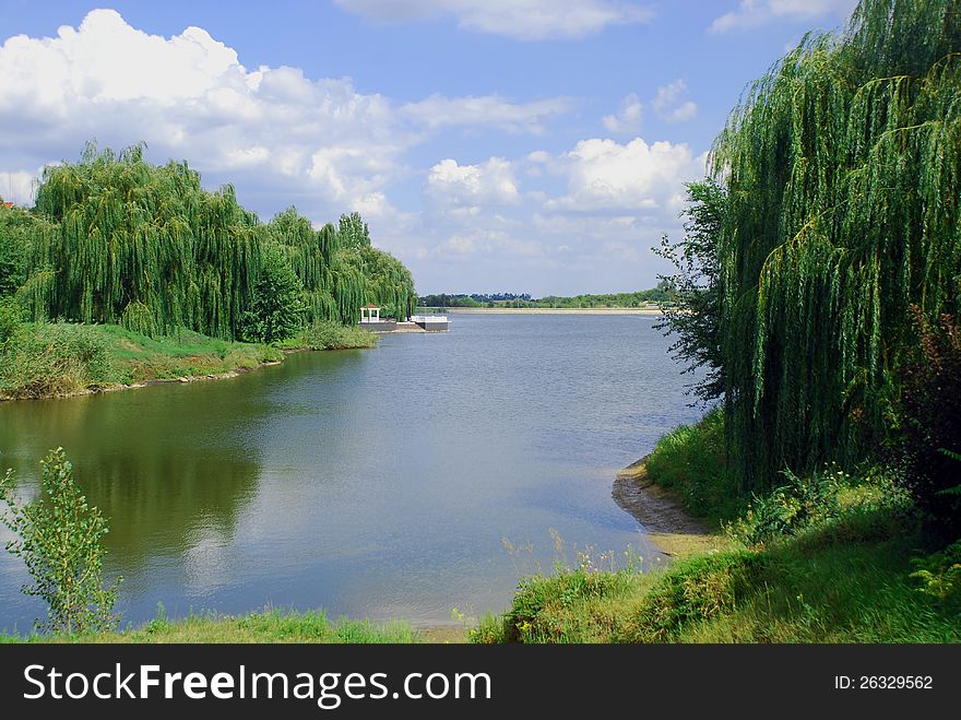 Blue lake with willows on the bank at the training base football team Shakhtar Donetsk, located outside the city in a clean area