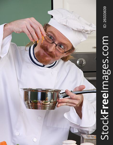 Funny young chef add carrots in the pot