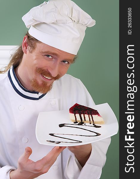 Young chef with piece of cake with chocolate sauce