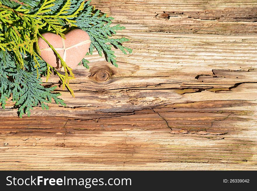 Branches and a heart on an old wood background. Branches and a heart on an old wood background