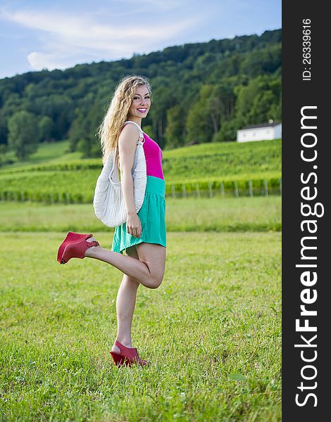 Pretty teenager girl posing in front of vineyards. Pretty teenager girl posing in front of vineyards