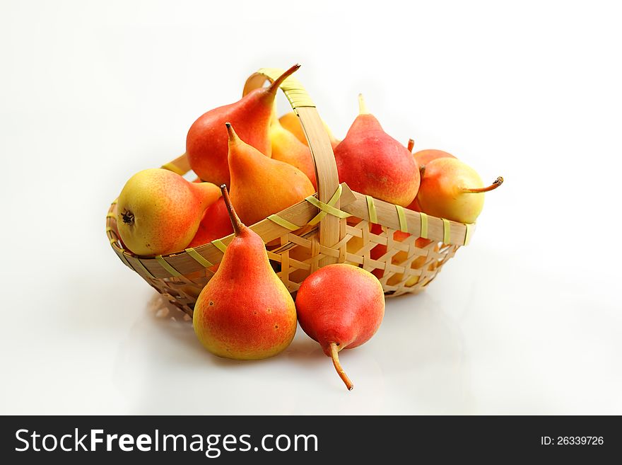 Juicy flavorful pears in basket on white